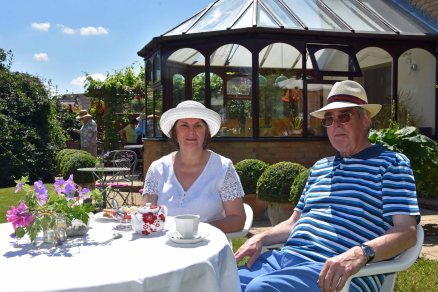 Celia and Philip Green enjoying tea and cake