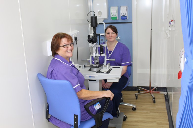 Allison Boughnimi and Hannah McGill at the eye examination machine