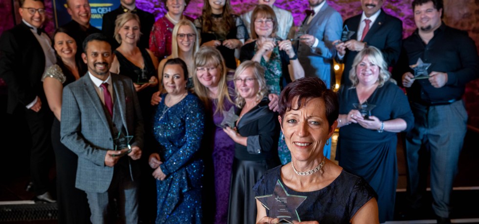 Linda Purdy, winner of The Chair's Award fronts the award winners from the 2022 Team QEH Awards