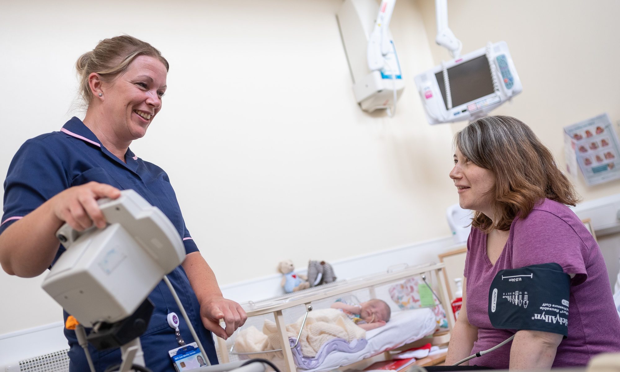 Midwife with mother and baby at QEH