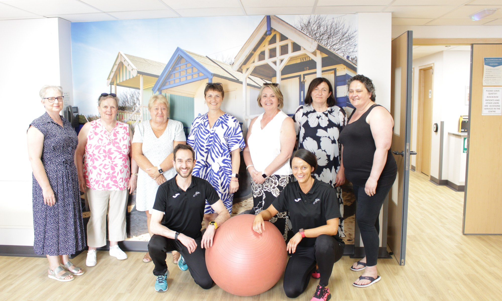 Members of the QEH physical activity programme for patients affected by cancer posing with Alive West Norfolk Cancer Rehabilitation Exercise Professionals Jose and Carolyn.