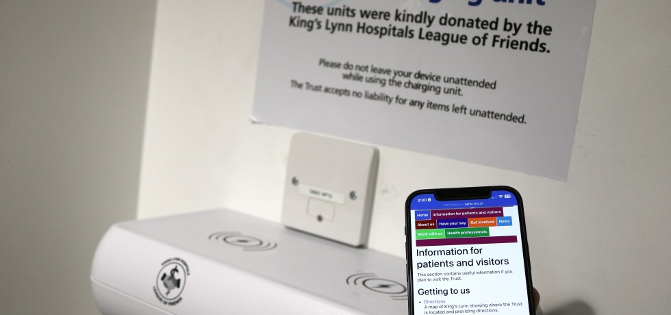 Someone about to place their phone on the charging port