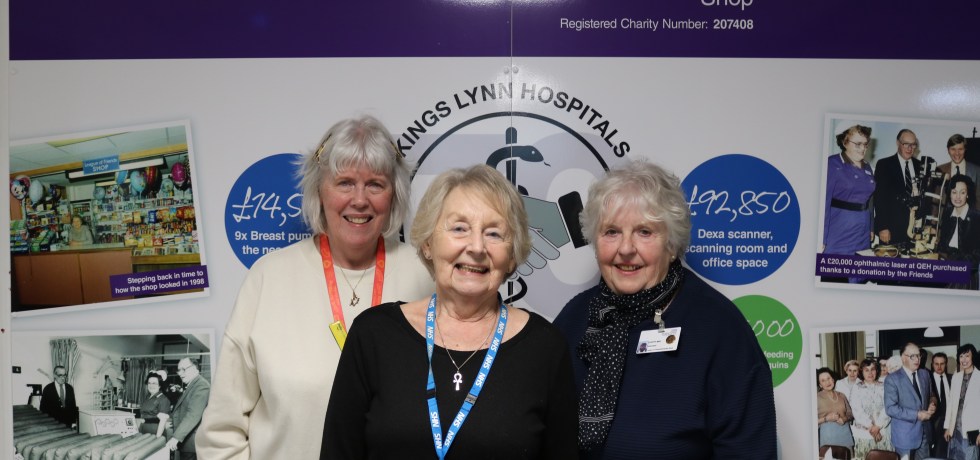 A picture of Marie Long, Penny Hipkin and Judy May standing in front of The League of Friends shop.