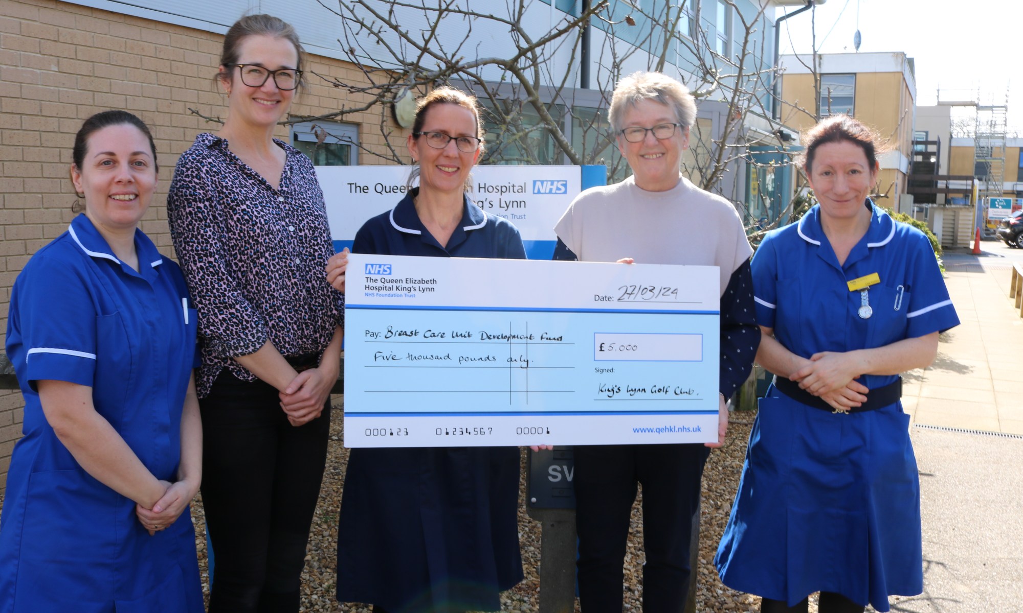 An image of Jane Reavell presenting a giant cheque to QEH Breast Care nurses Amy Burger, Elaine Rudd, Gemma Harnwell and Lisa Curson.