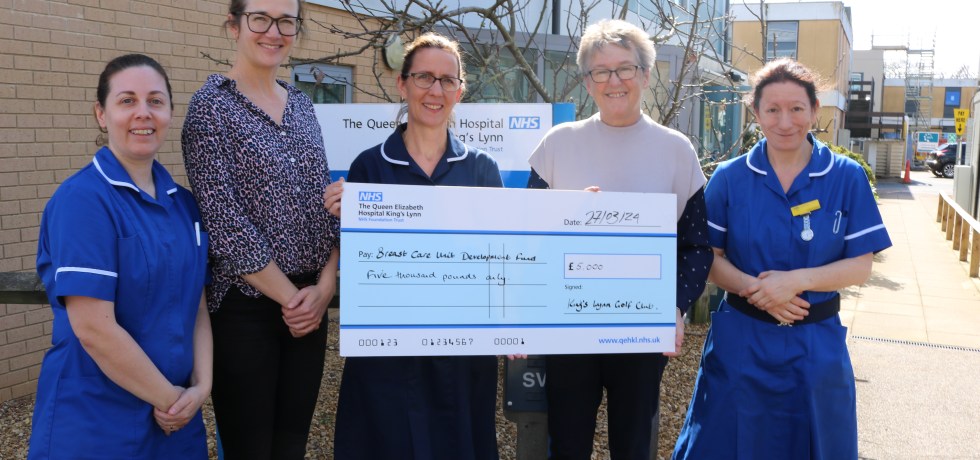An image of Jane Reavell presenting a giant cheque to QEH Breast Care nurses Amy Burger, Elaine Rudd, Gemma Harnwell and Lisa Curson.