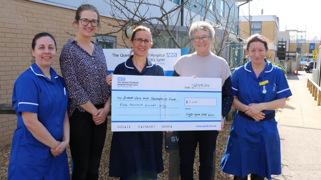 Jane Reavell presenting a giant cheque to Breast Care Nurses Amy Burger, Elaine Rudd, Gamma Harnwell and Lisa Curson