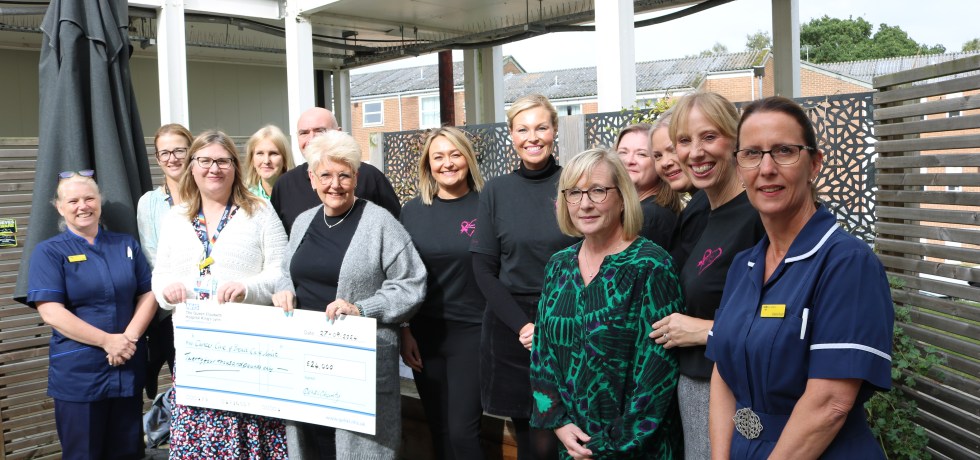 Members of the Breast of Friends presenting a novelty cheque to nurses and Medical Director, Dr Rebecca Martin.