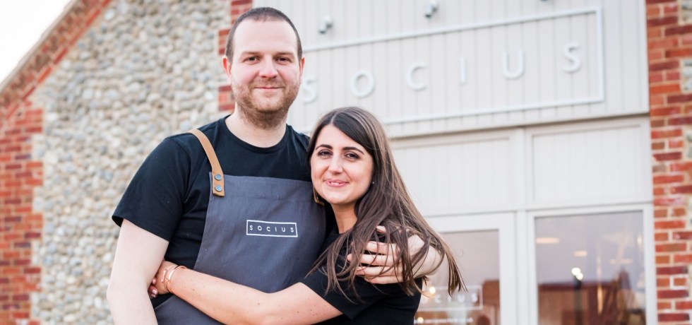 A picture of Socius owners - Natalie and Dan Lawrence in front of the restaurant