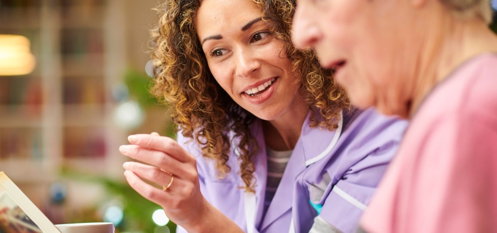 Care nurse visit to senior woman