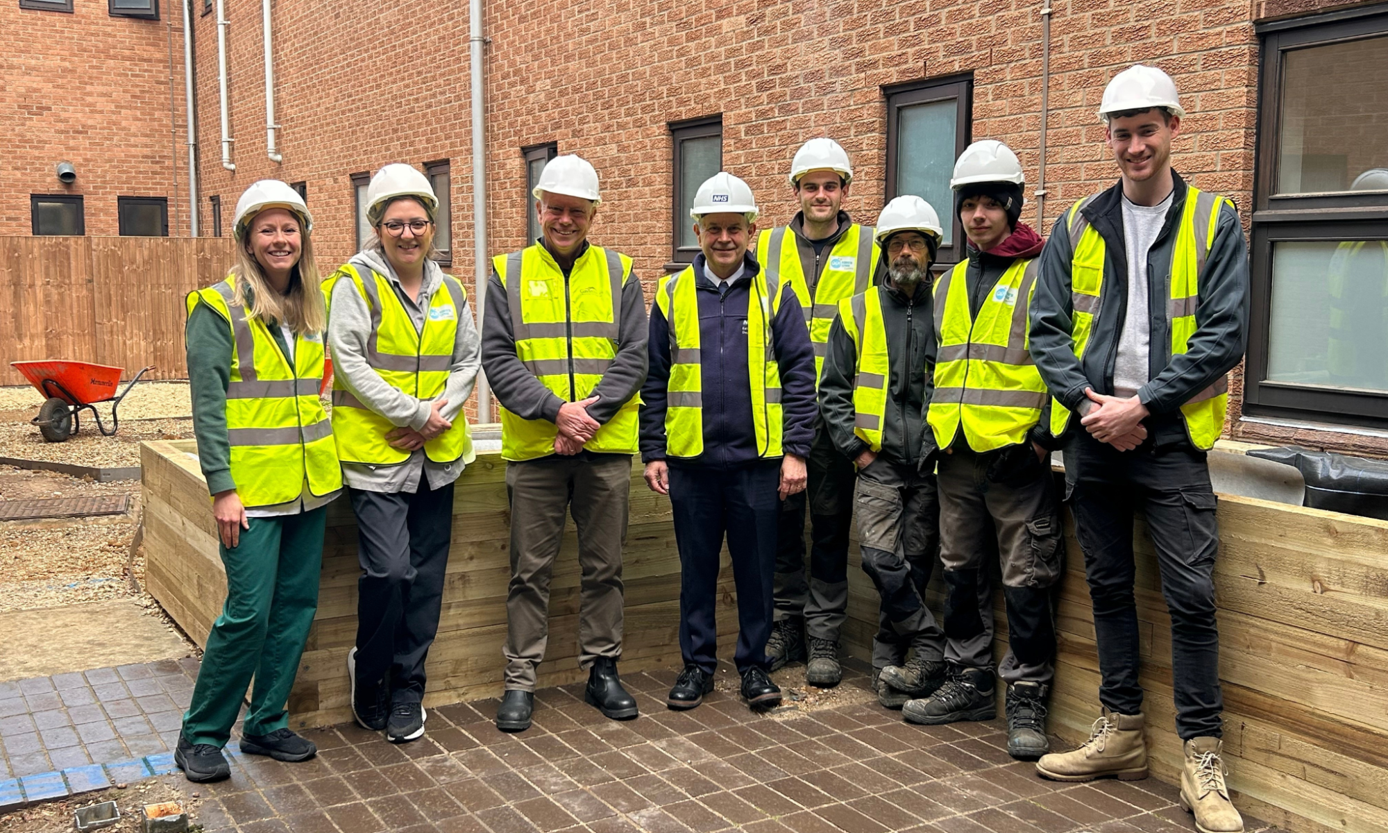 A picture of the building team and stroke rehab nurses outside the area which will become the Stroke Rehabilitation Garden