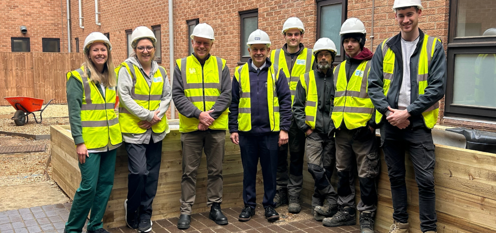 A picture of the building team and stroke rehab nurses outside the area which will become the Stroke Rehabilitation Garden