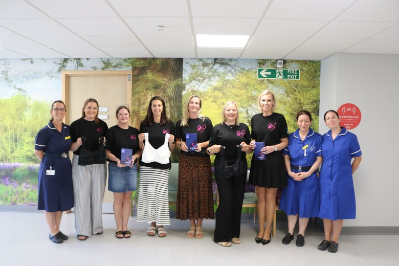 Member of the Breast of Friends and nurses holding specialised bras & their boxes