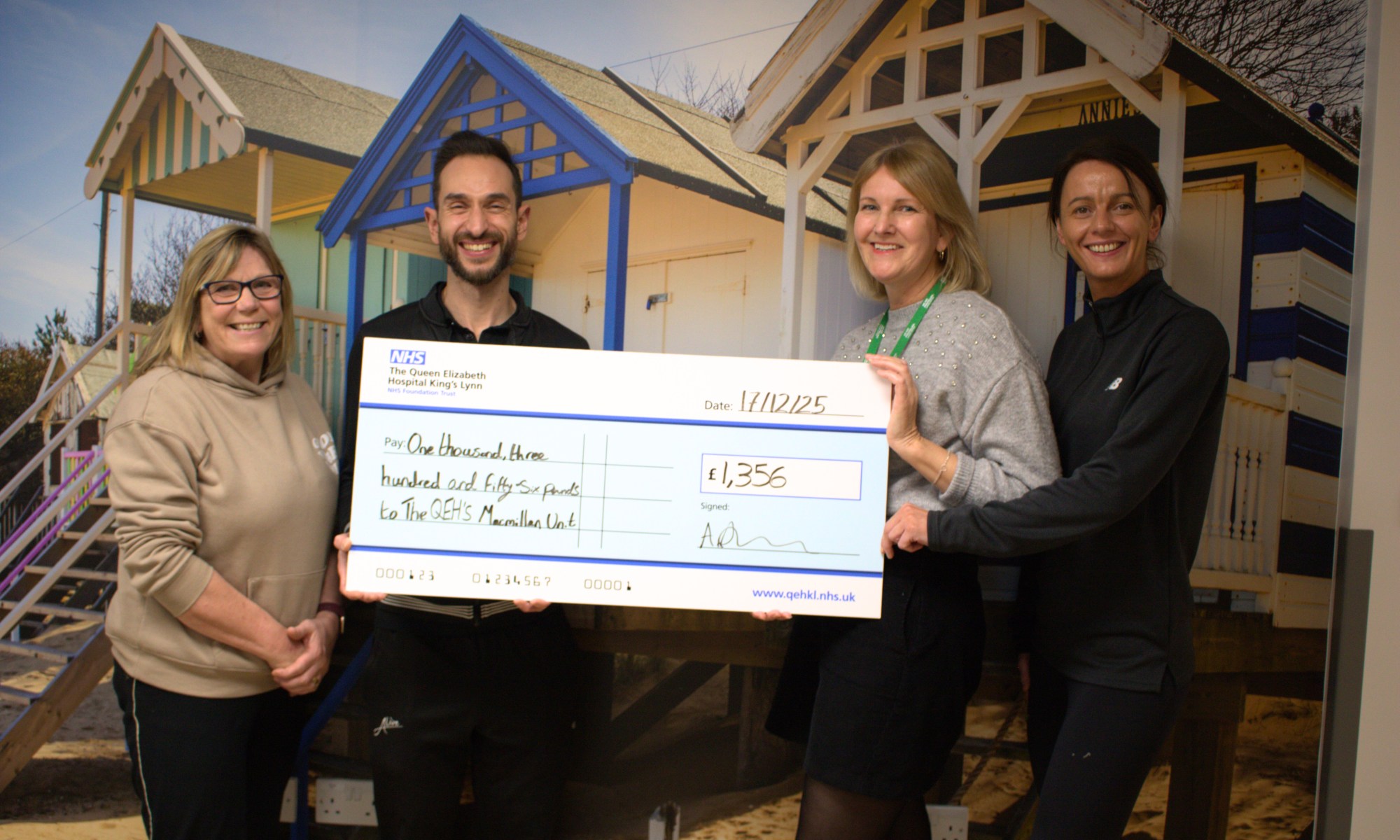A photo of Alive Wast Norfolk being presented a giant novelty cheque worth £1,356 to the Cancer Care Unit