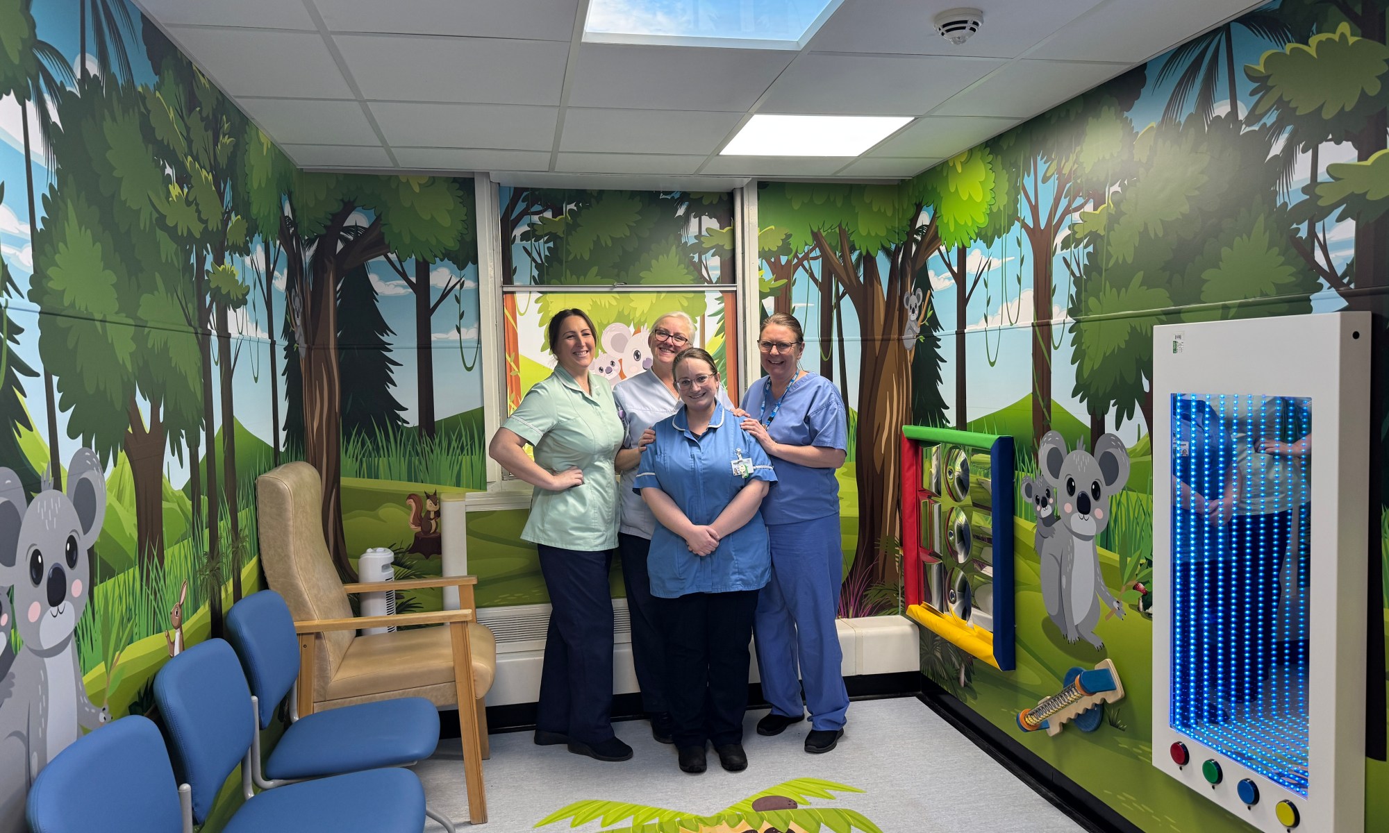 A photo of four nurses standing in the new children's waiting room area