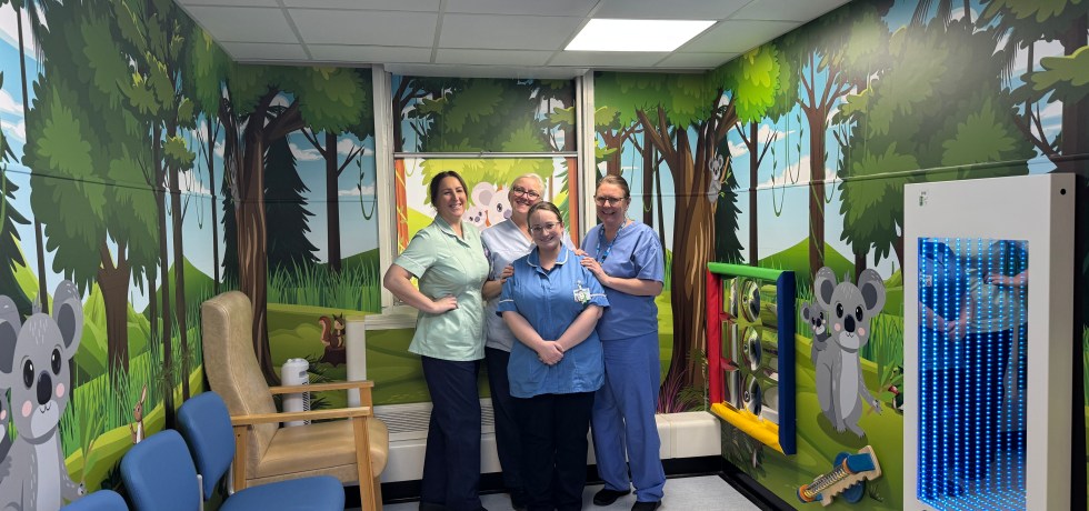 A photo of four nurses standing in the new children's waiting room area