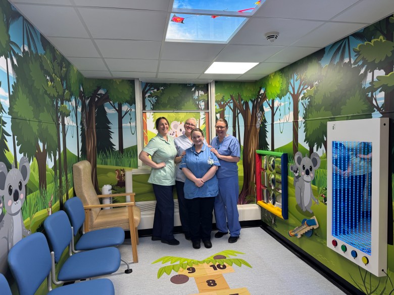 A photo of four nurses standing in the new children's waiting room area