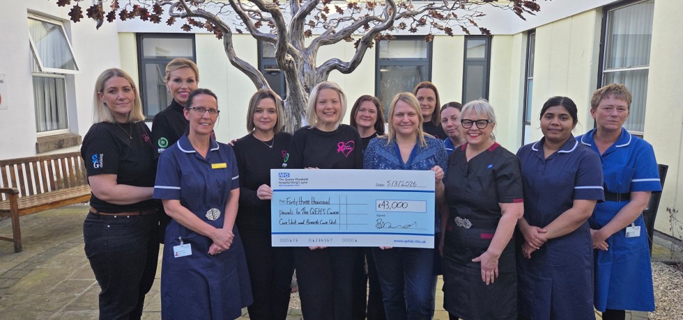 Breast of Friends representatives holding a giant novelty cheque worth £43,000 to Interim Chief Nurse Dawn Collins and other staff nurses