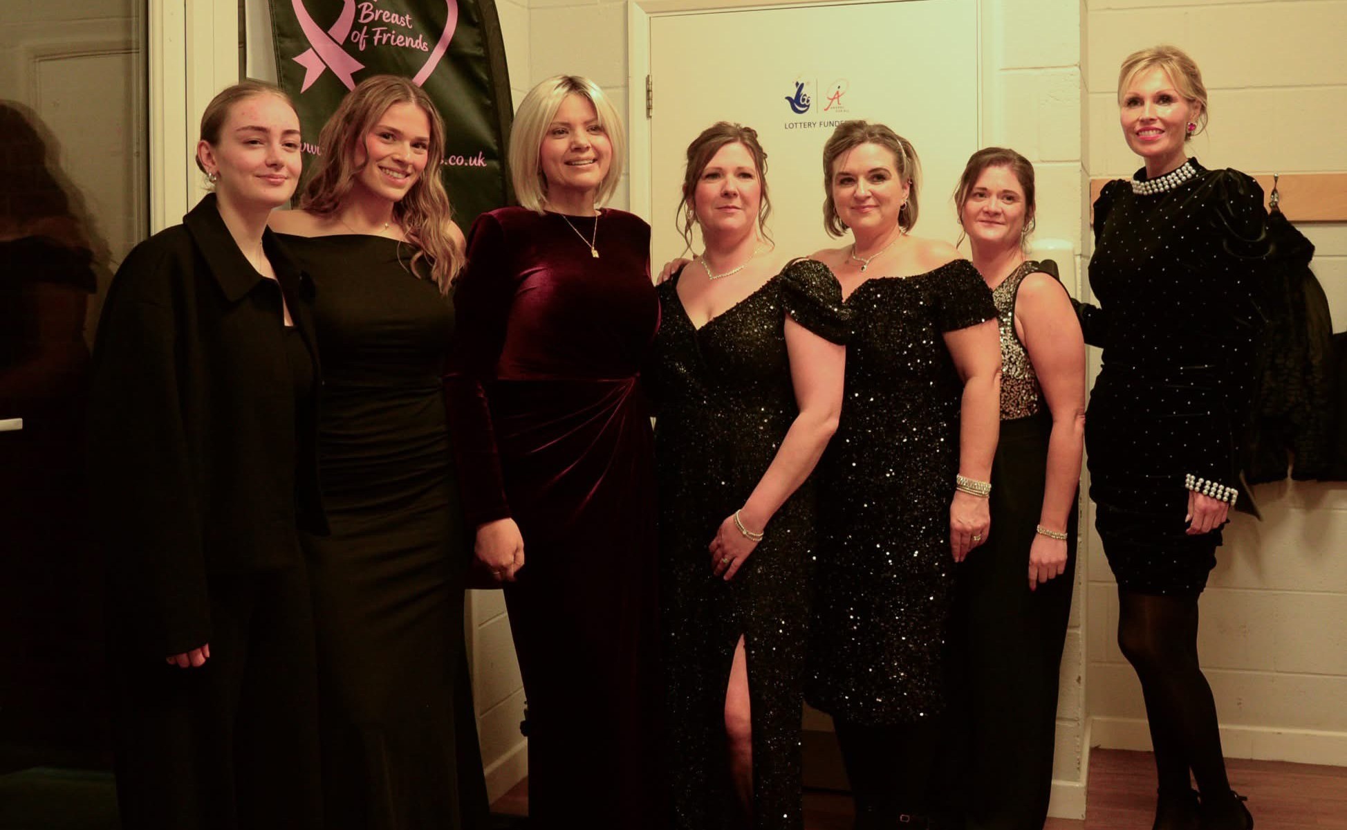The Breast of Friends wearing black dresses at the casino night