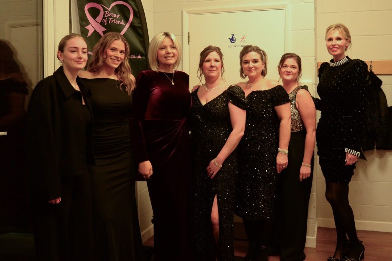 The Breast of Friends wearing black dresses at the casino night