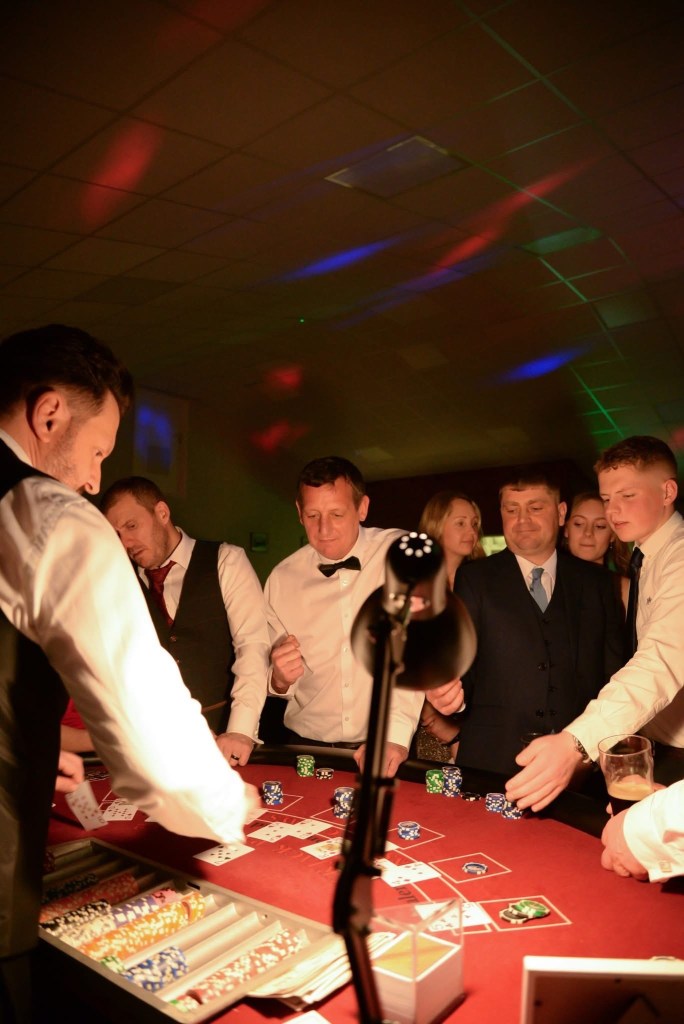 Casino night photo of people playing black jack