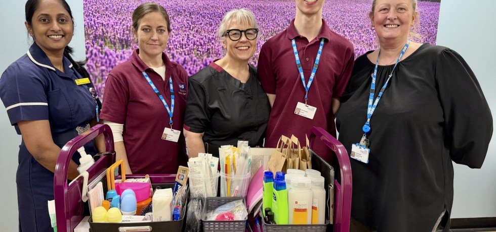 Sithara Thundathil Sunny Joseph, volunteer Laura, Interim Chief Nurse Dawn Collins, volunteer Caleb and Alison Paget standing in front of the comfort trolley,