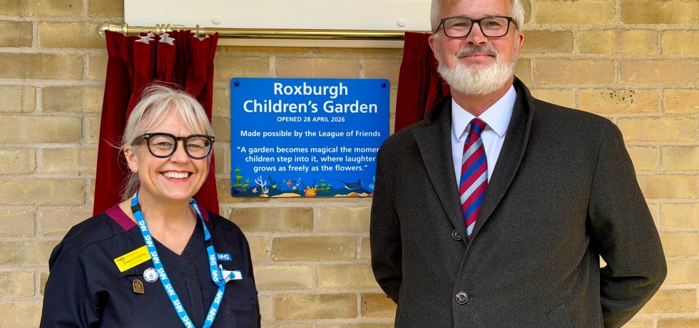 Dawn Collins and Alistair Roxburgh standing outside the newly revealed plaque.