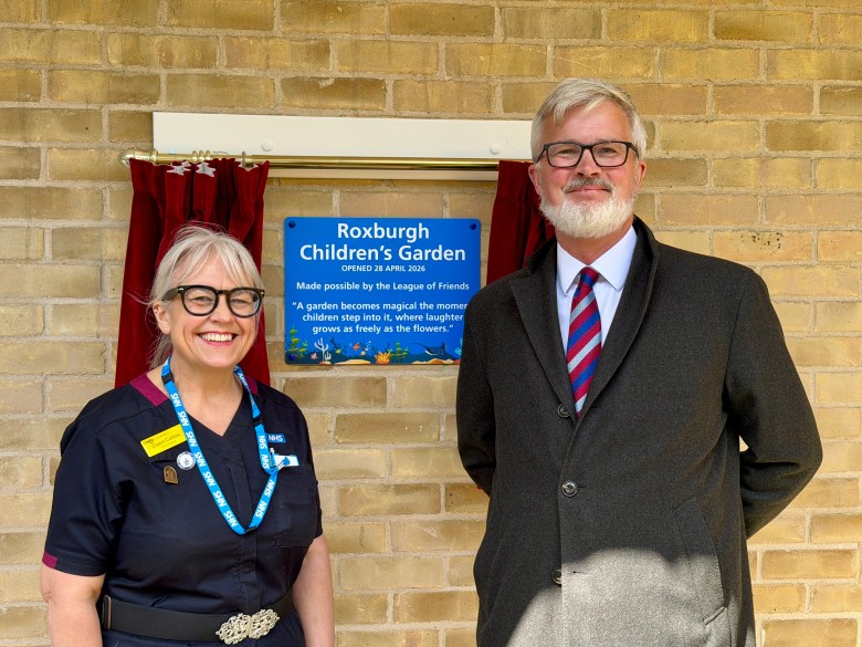 Dawn Collins and Alistair Roxburgh standing outside the newly revealed plaque.