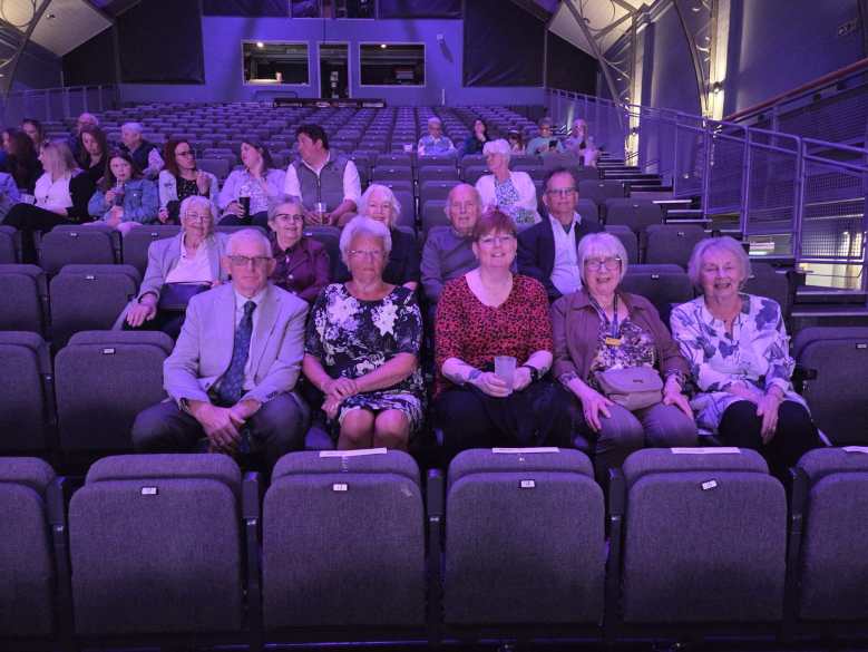 Five members of The League of Friends sat in theatre chairs.