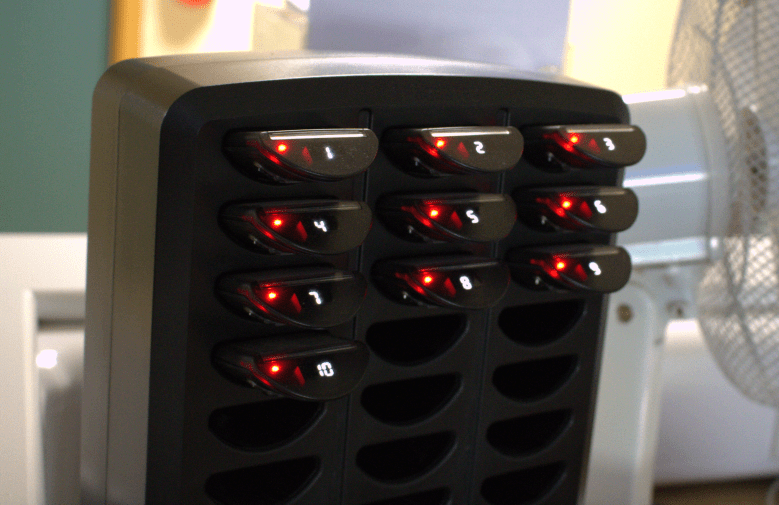 A close-up photo of the pager charger system with numbers of them 1-10
