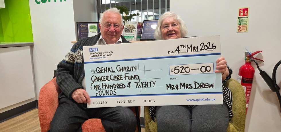 A photo of David and Caroline Drew holding a giant novelty cheque worth £520 for the Queen Elizabeth Hospital King's Lynn's Cancer Care Fund