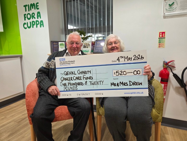 A photo of David and Caroline Drew holding a giant novelty cheque worth £520 for the Queen Elizabeth Hospital King's Lynn's Cancer Care Fund