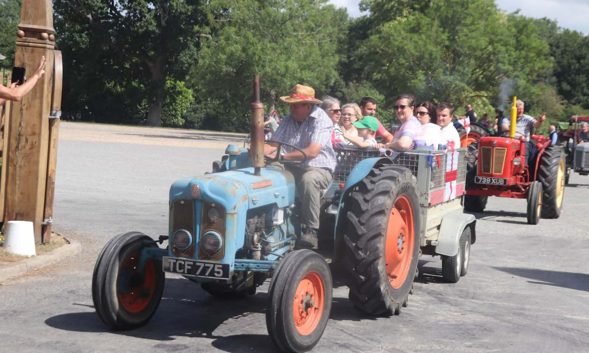 A photo of a row of tractors driving by