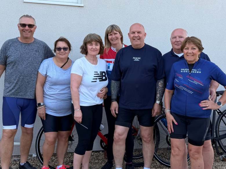 A photo of people stood in cycling gear next to a row of bikes. Included in the photo is Robert Melton, Alison Melton, Julie Follen, Nick Anderson, Kim Anderson, Robbie Maher and Mandy Maher.