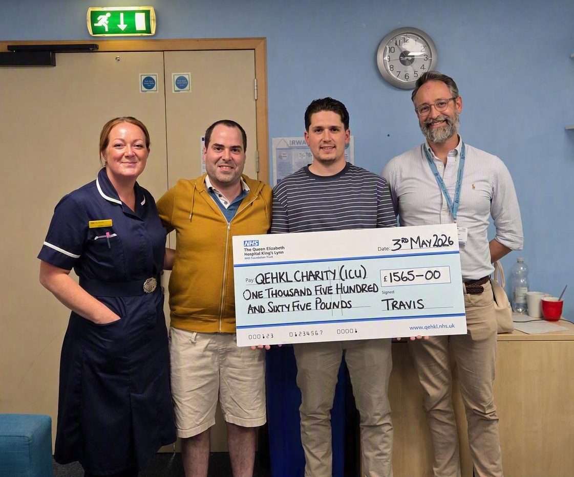 A photo of a nurse (Emma Hampton), Sergio Figueiredo, Travis Toll and Dr Phillip Hassle holding up a giant novelty cheque worth £1,565 for The QEH's Intensive Care Unit